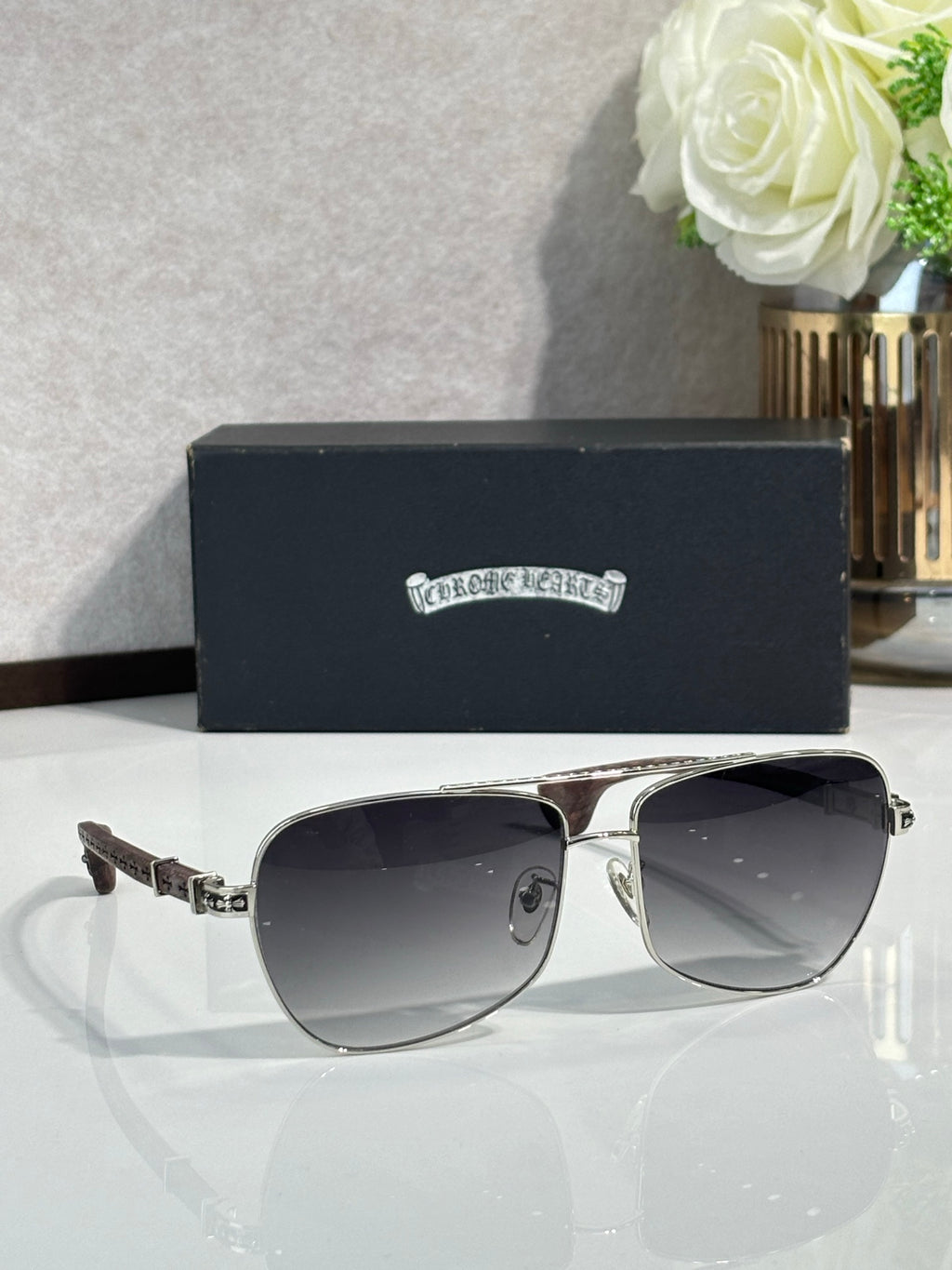 Silver-tone aviator sunglasses with dark gradient lenses and brown patterned temples