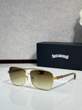 Gold-tone square sunglasses with gradient amber lenses and rhinestone logo temple