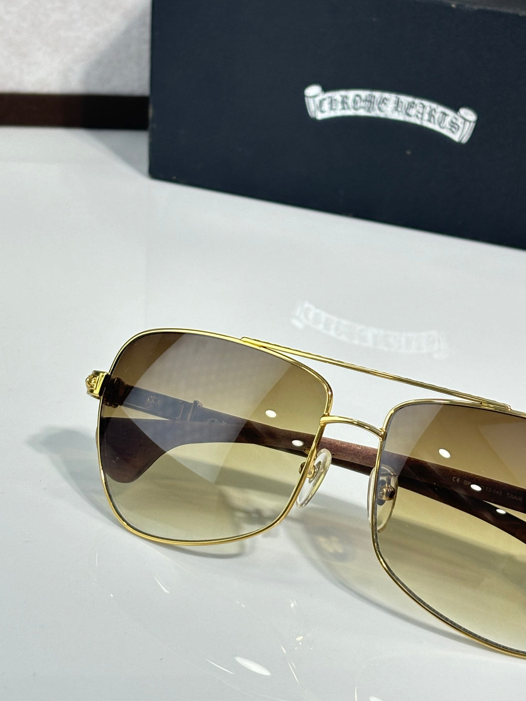 Gold-tone oversized sunglasses with light-tinted gradient lenses and rhinestone details