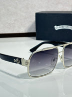 Gold sunglasses with dark lenses, square frames, and decorative side motifs