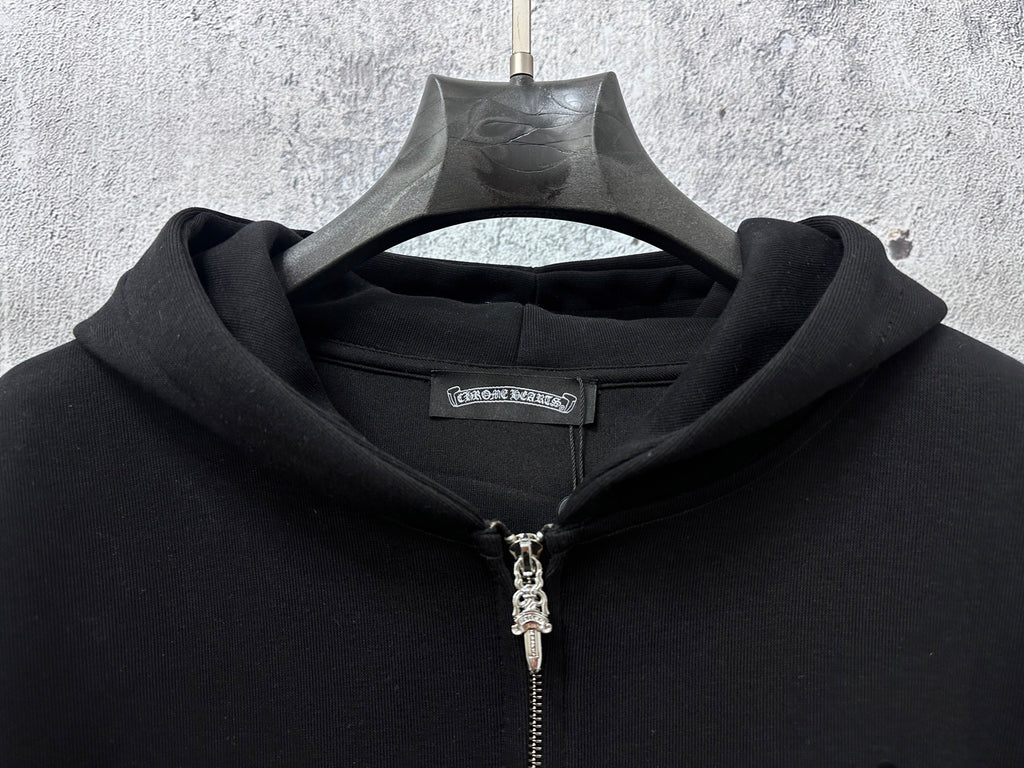 Black zip-up hoodie neckline with front silver zipper and hood drawstring