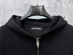 Black zip-up hoodie neckline with front silver zipper and hood drawstring