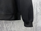 Black zip-up hoodie cuffs and hem with ribbed sleeve ends and pocket seam