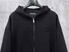 Black zip-up hoodie with rhinestone star-like chest emblem and silver zipper