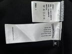 Black zip-up hoodie size label and care tags, marked M