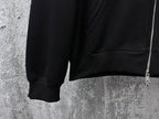 Black hoodie lower front with ribbed hem and kangaroo pocket opening