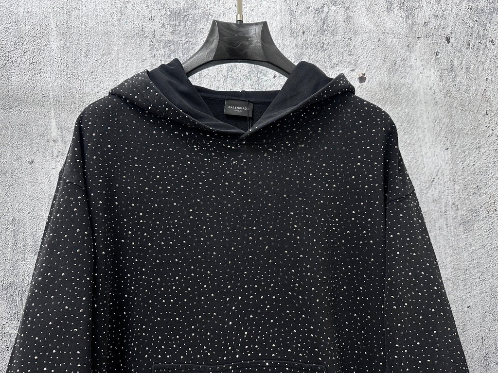 Balenciaga long-sleeve hoodie front, dark with white speckle print, hood detail