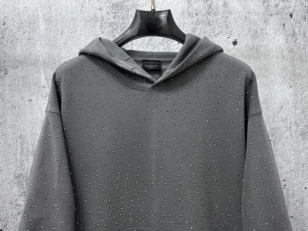 Long-sleeve hoodie, dark gray with hood and speckled dots, centered front view