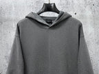 Long-sleeve hoodie, dark gray with hood and speckled dots, centered front view