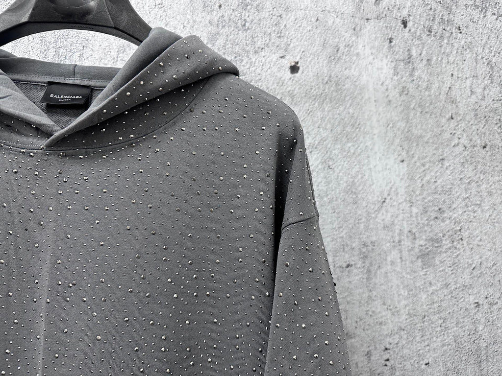 Hooded sweatshirt detail, dark gray with speckled dot pattern near the collar