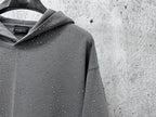 Hooded sweatshirt detail, dark gray with speckled dot pattern near the collar