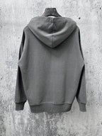 Long-sleeve hoodie back view, dark gray with attached hood and speckled dots