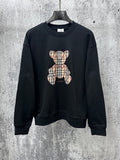 Black long-sleeve sweatshirt with plaid teddy bear graphic on front