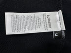 Burberry size and care label on black sweatshirt interior, size M tag