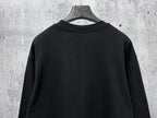 Black long-sleeve sweatshirt back view with ribbed neckline and hem