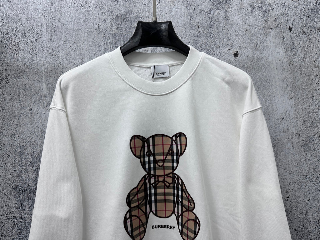 White crewneck sweatshirt with Burberry check-pattern teddy graphic at chest