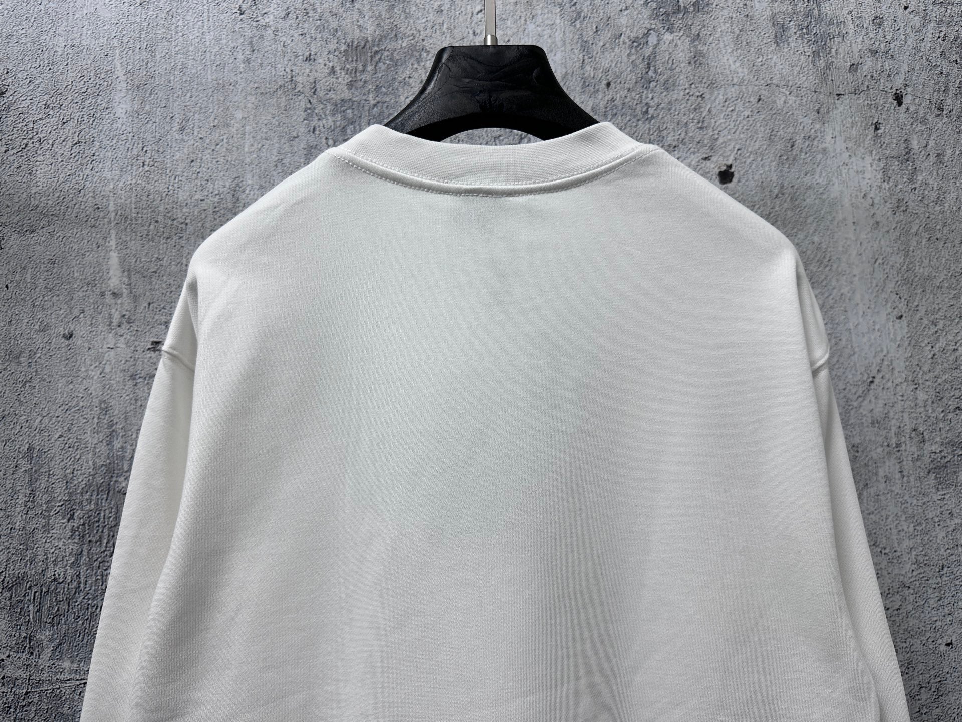 White crewneck long-sleeve sweatshirt, plain back with ribbed hem and cuffs