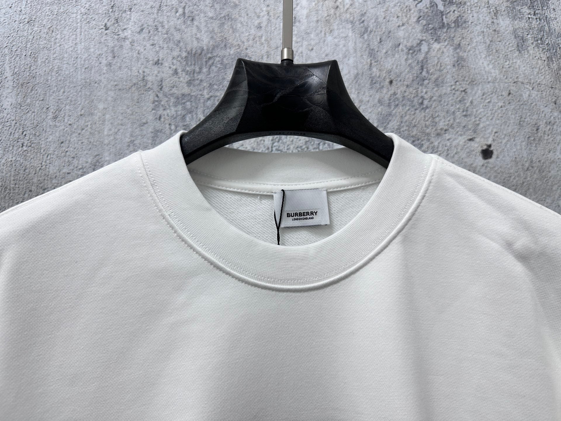 White sweatshirt neck with inner collar label, ribbed trim and clean front