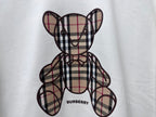 Check-pattern teddy bear graphic on white sweatshirt with Burberry text