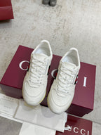Pair of white Gucci leather lace-up sneakers with green-red stripe and yellow sole