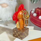 Louis Vuitton bear charm keychain with gold keyring and small tag, red flower head