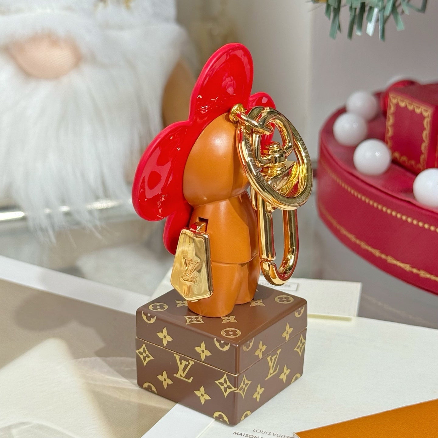 Louis Vuitton bear charm keychain with gold keyring and small tag, red flower head