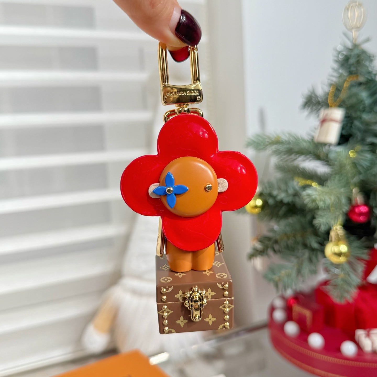 Louis Vuitton bear charm keychain on small brown monogram box, red flower head