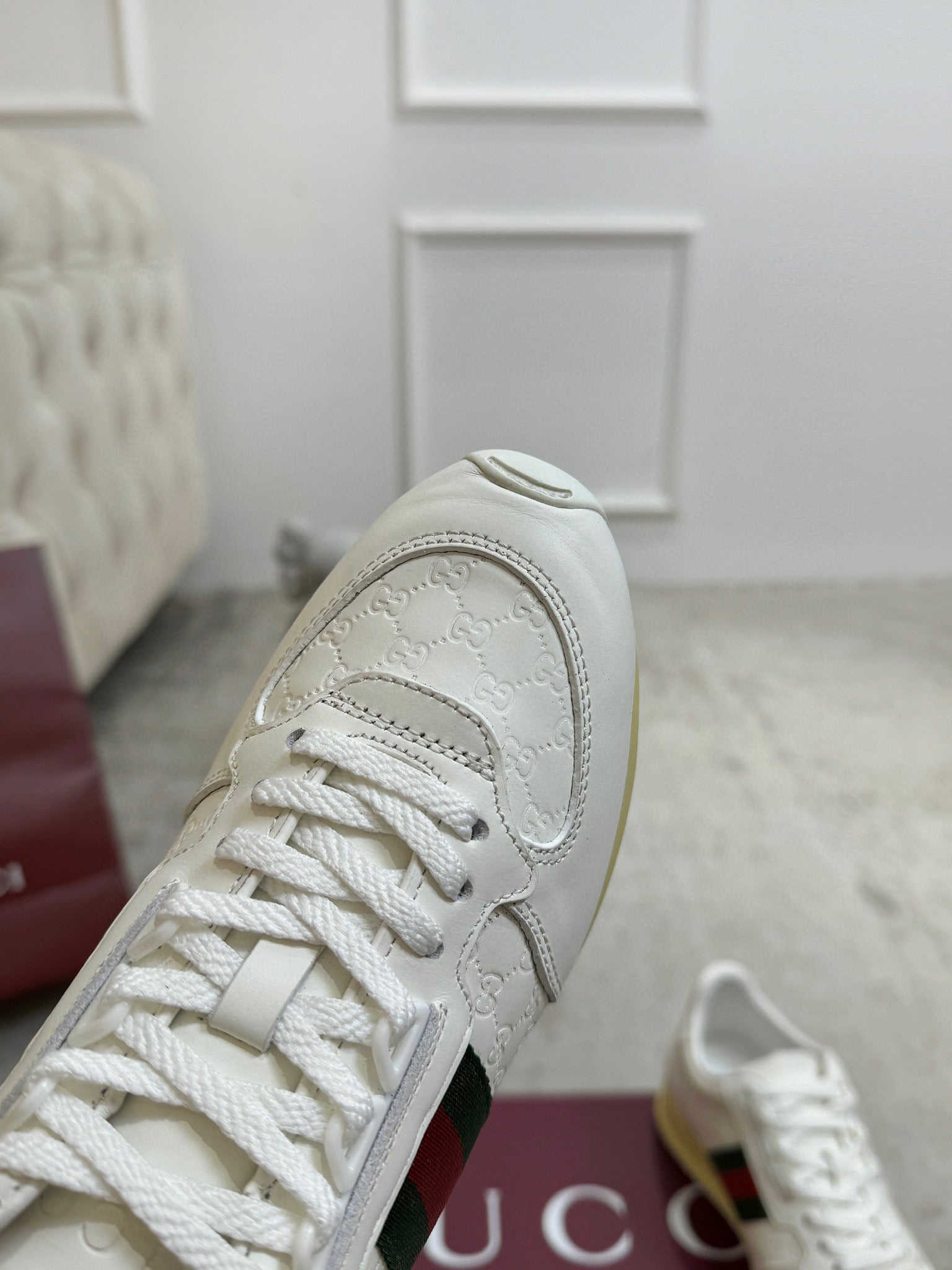 Gucci unisex sneaker close-up of toe and laces on white leather upper