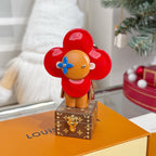 Louis Vuitton bear charm keychain standing on brown monogram base, red flower head