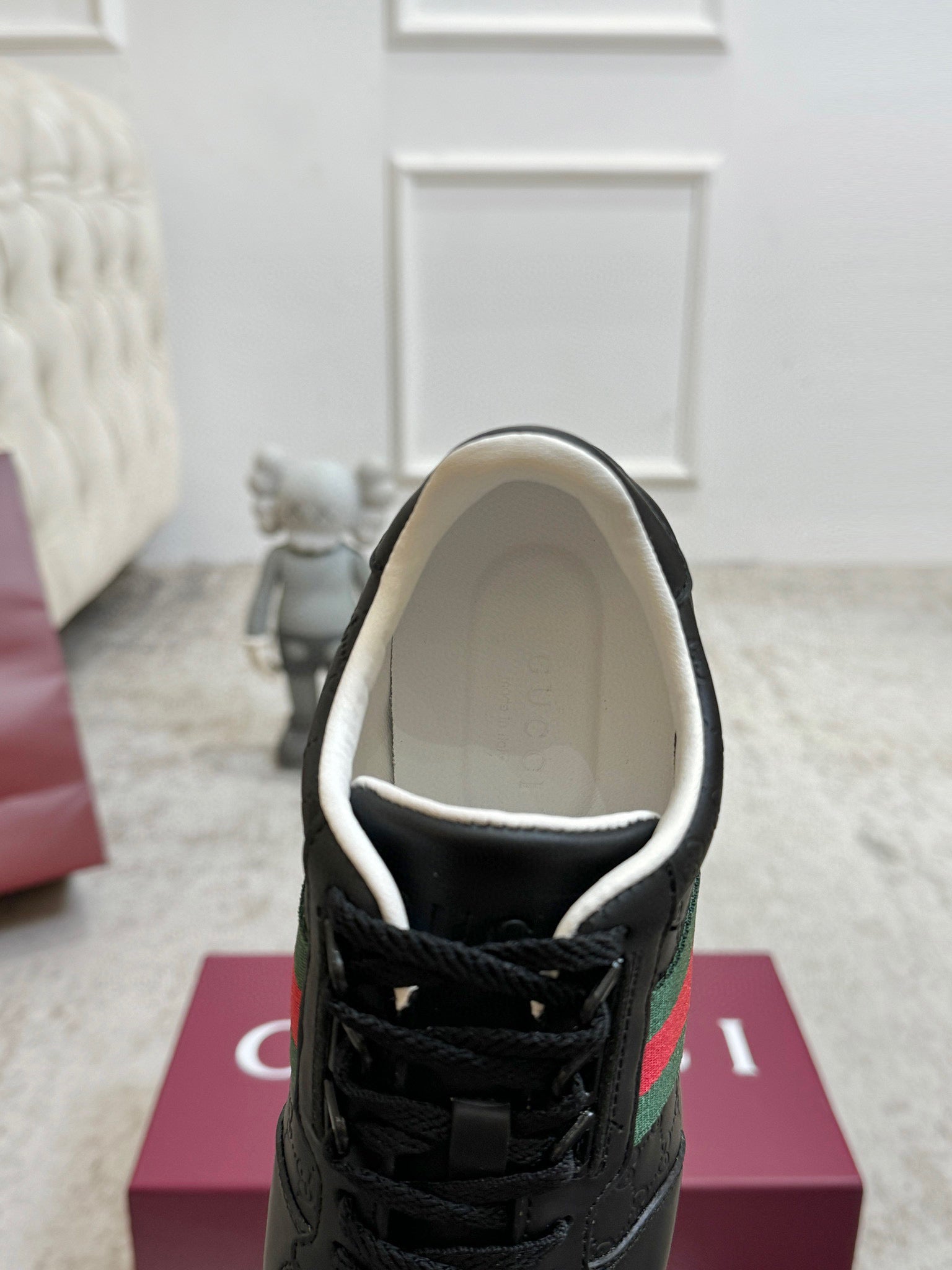 Gucci unisex sneakers, black lace-up, interior lining visible with padded collar