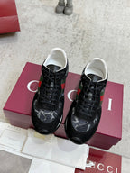 Gucci unisex sneakers, black lace-up pair with green and red stripe accents