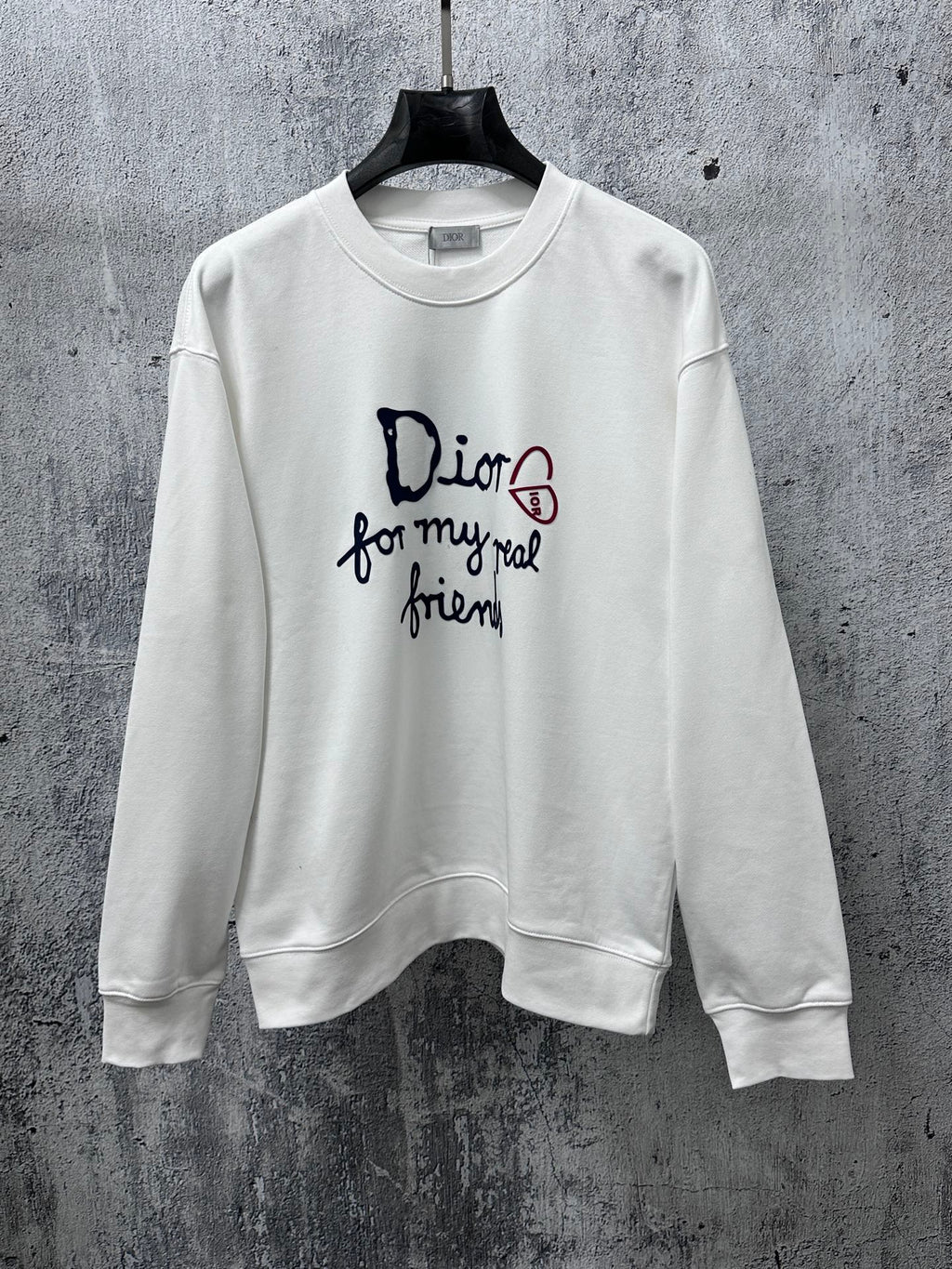White long-sleeve sweatshirt with Dior logo and text graphic on chest