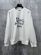 White long-sleeve sweatshirt with Dior logo and text graphic on chest