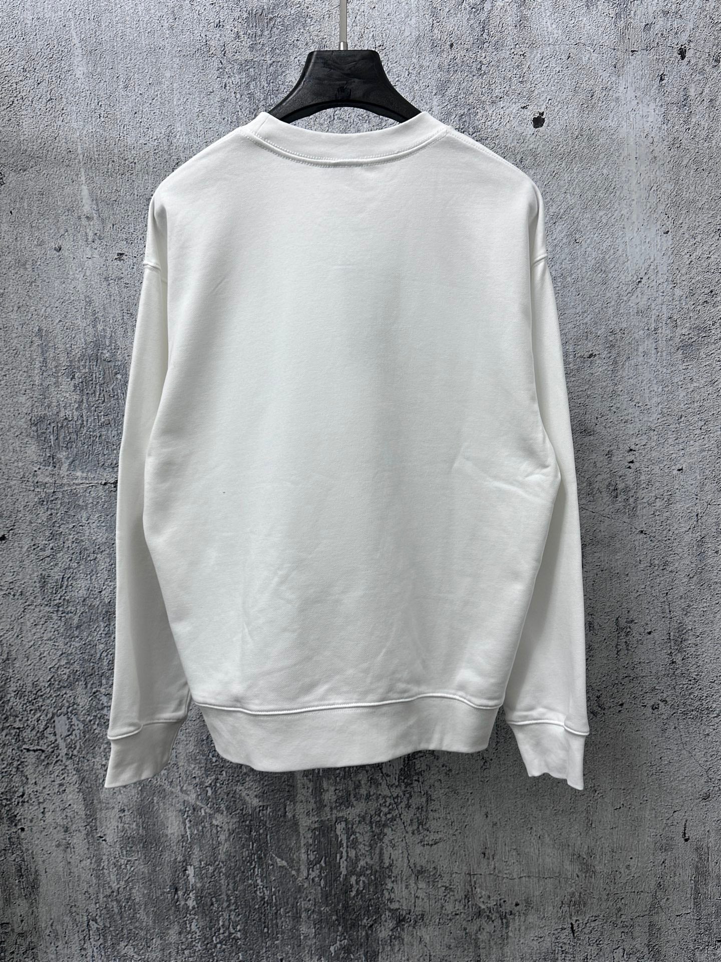 White long-sleeve sweatshirt back view, ribbed crew neck and cuffs