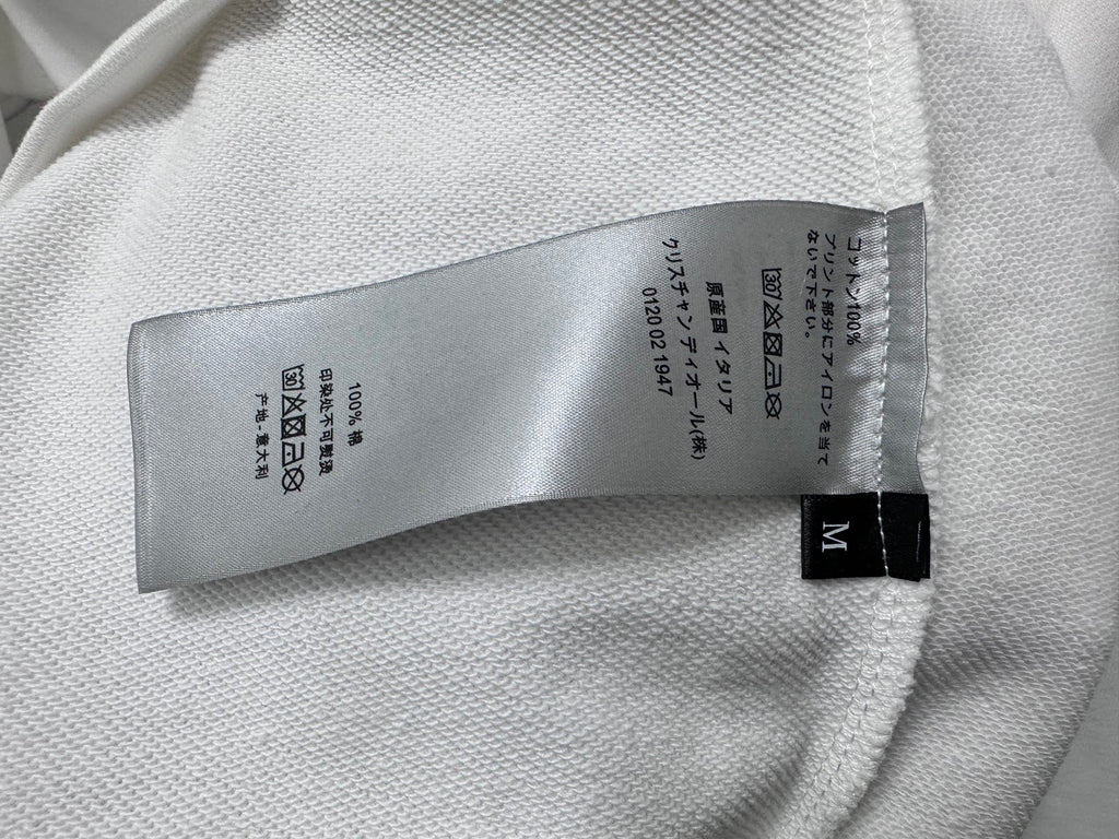 Inside neck care label on white sweatshirt with Dior tag