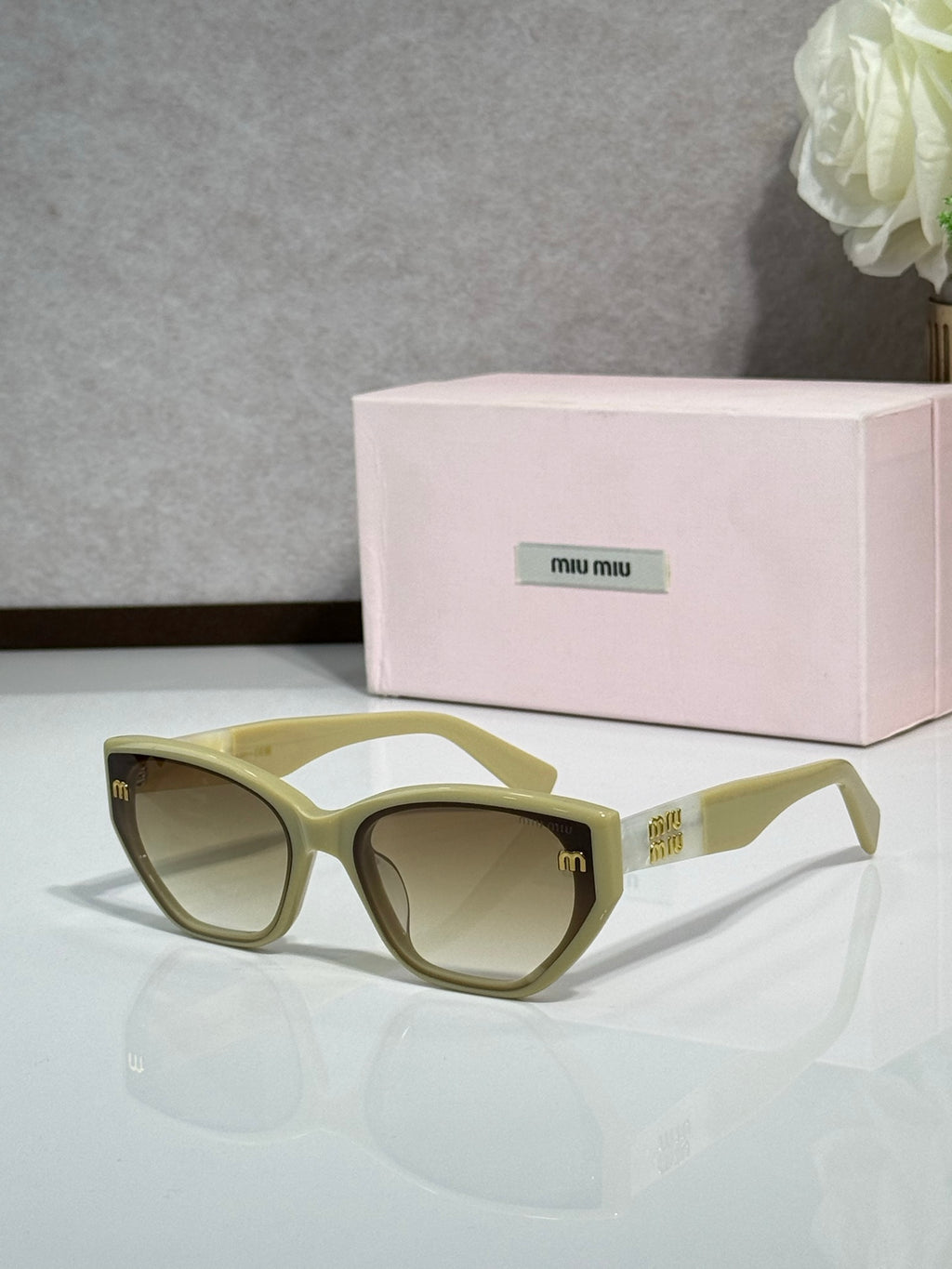 Olive green sunglasses with tinted lenses and pink logo case