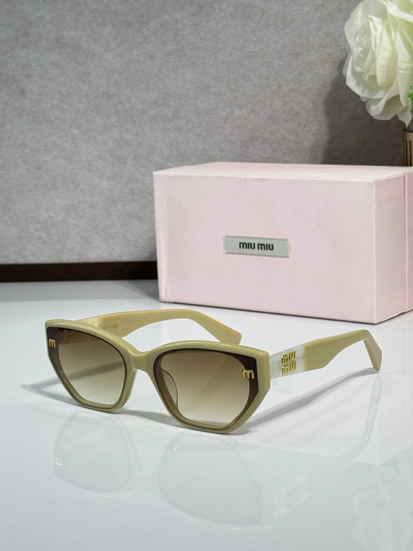 Olive green sunglasses with tinted lenses and pink logo case