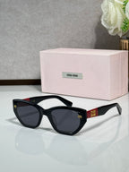 Black sunglasses with dark lenses and pink logo case
