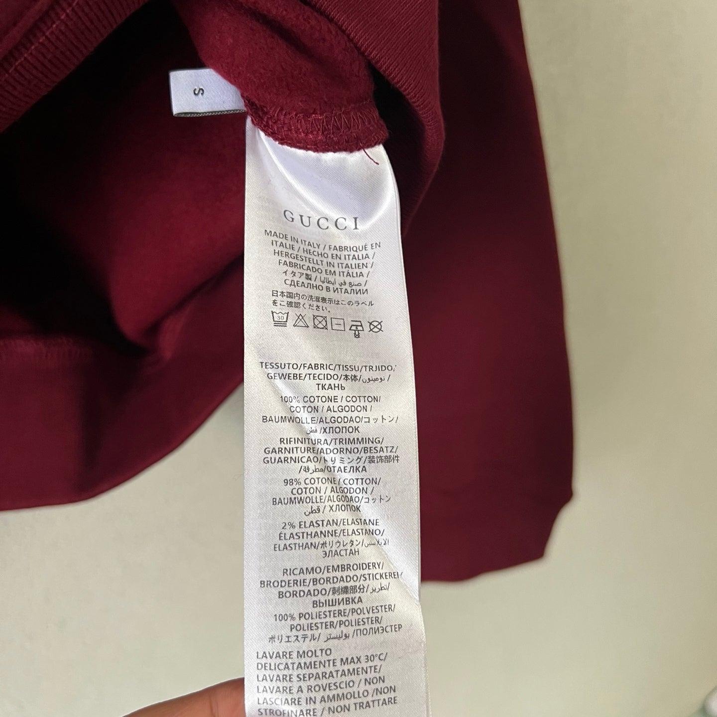 Gucci maroon sweatshirt inside neck fabric care label and stitch seam