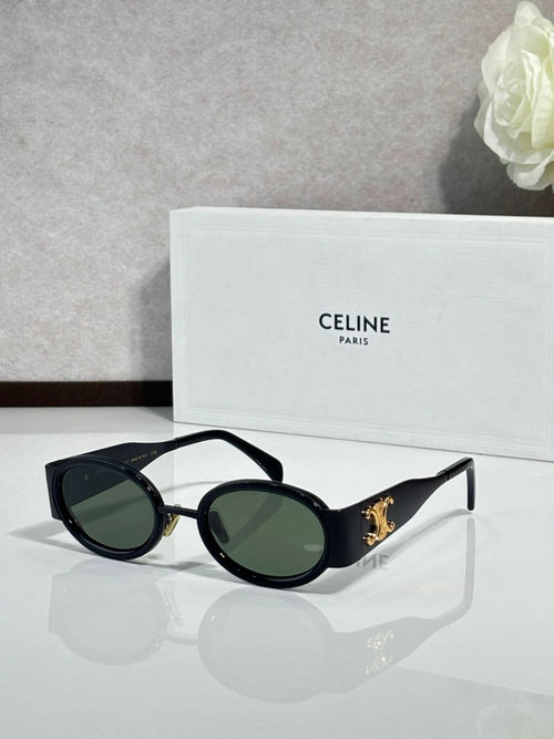 Celine oval black glasses with gold accents and dark lenses