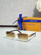 Louis Vuitton sunglasses with dark gold frames and amber lenses