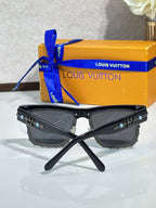 Louis Vuitton square sunglasses with black frames, dark lenses, and crossed display stand