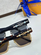 Louis Vuitton sunglasses with ornate gold-tone temple hardware and tinted lenses