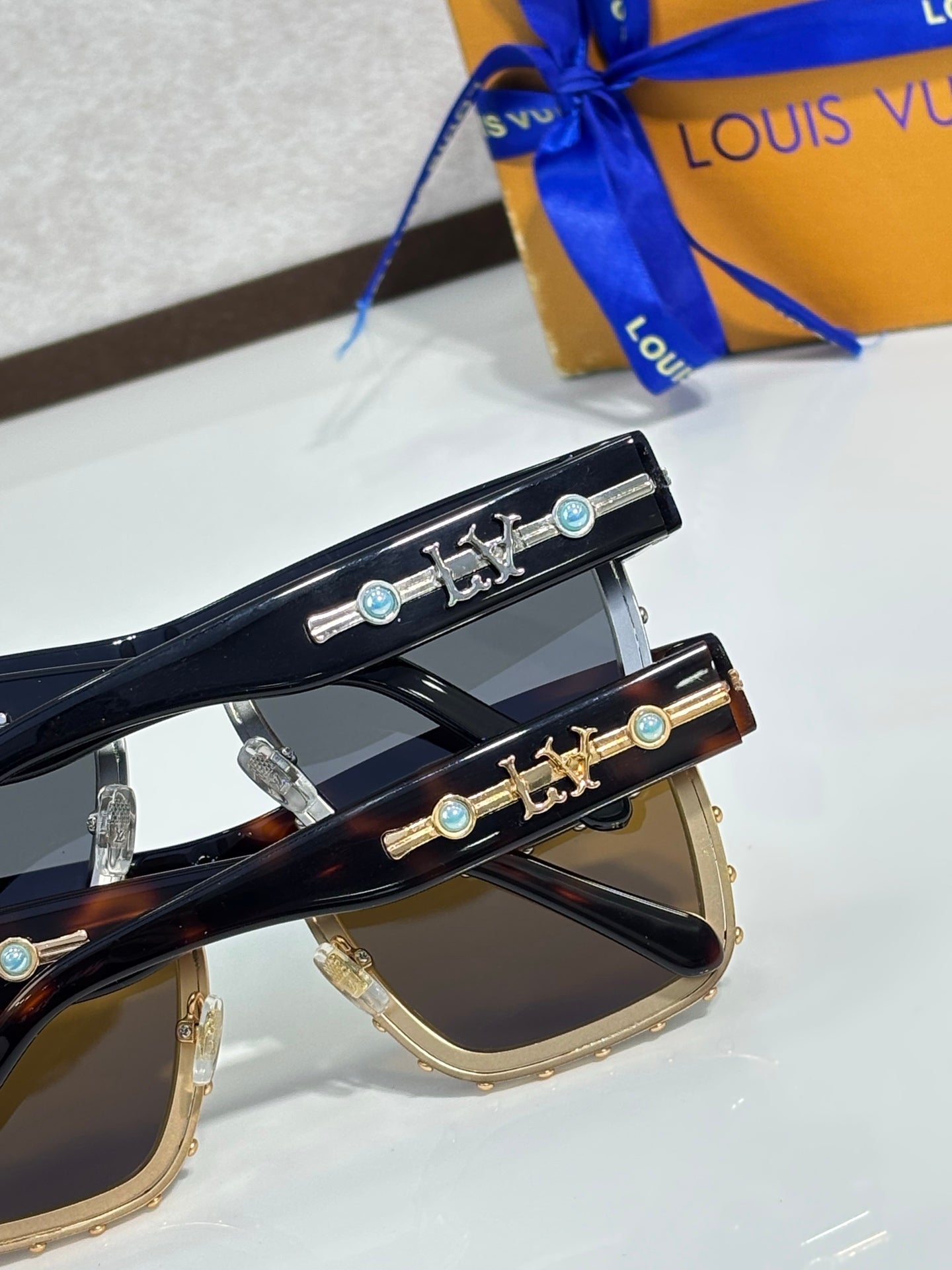 Louis Vuitton sunglasses with ornate gold-tone temple hardware and tinted lenses