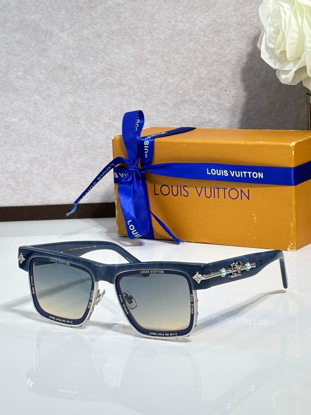 Louis Vuitton square sunglasses with dark lenses and black frames, side angle