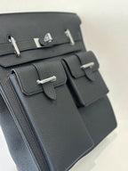 Hermes pebbled leather flap bag close-up of front panels, silver bar hardware