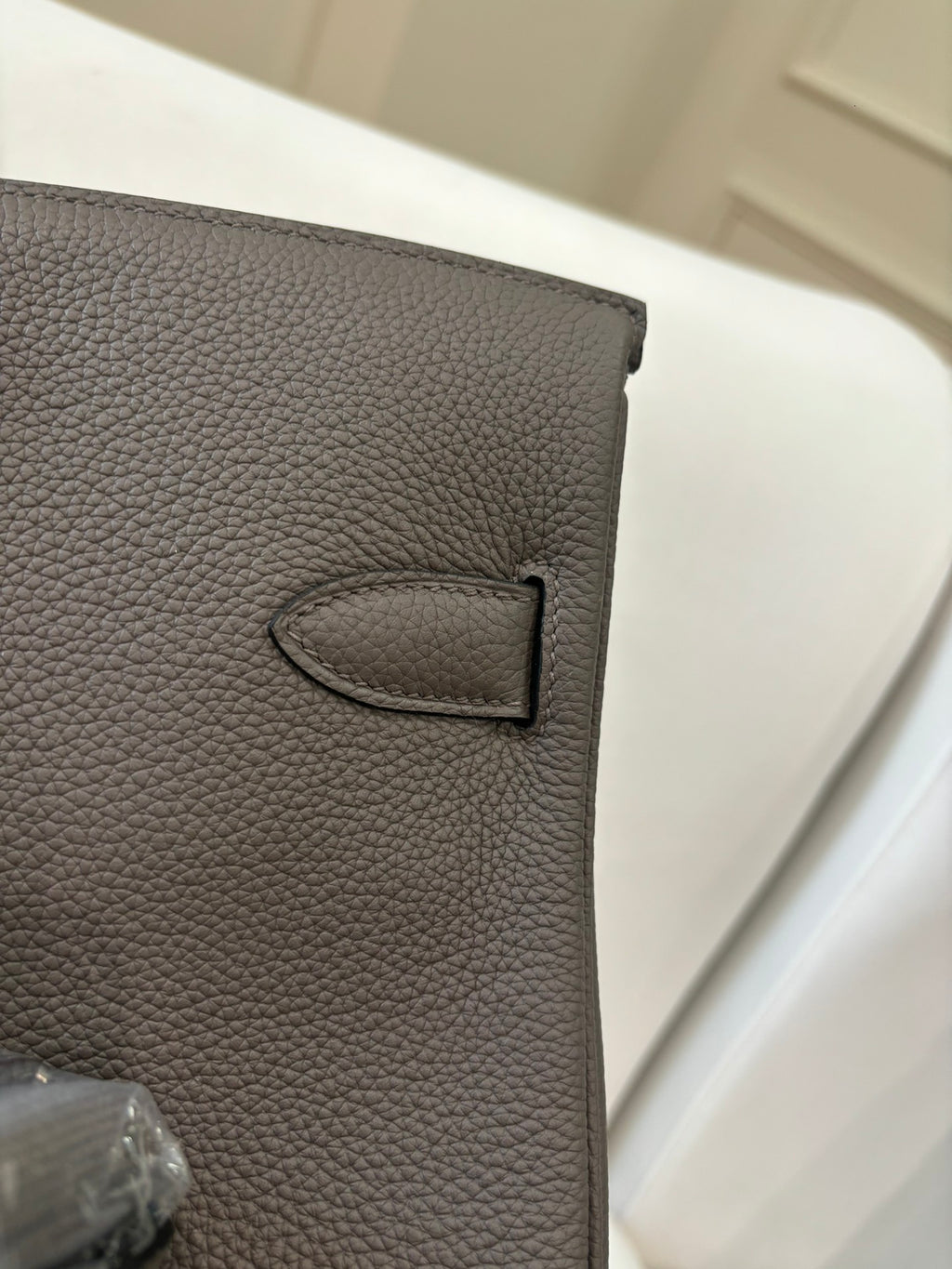 Hermes leather handbag close-up in gray with stitched D-ring detail