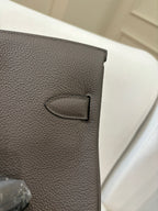 Hermes leather handbag close-up in gray with stitched D-ring detail