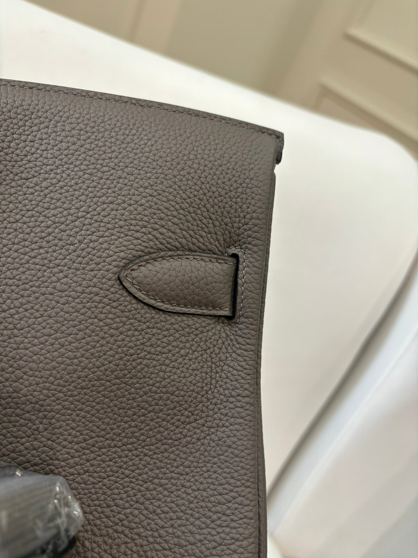Hermes leather handbag close-up in gray with stitched D-ring detail