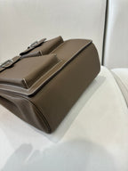 Hermes bag in taupe leather, angled side view with flap and structured body